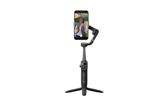 DJI Osmo Mobile 6 in black with a smartphone mounted and set on a tripod for stable video recording